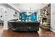 Cozy living room featuring a stone fireplace, dark leather sofa and TV at 865 Wingthorn Rose Dr, Gastonia, NC 28056