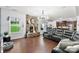 Open-concept living room with fireplace, hardwood floors, and natural light streaming through the windows at 865 Wingthorn Rose Dr, Gastonia, NC 28056