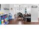 Open-concept area with a play area, dining table, and office space featuring wood floors at 865 Wingthorn Rose Dr, Gastonia, NC 28056