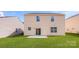 Backyard featuring green lawn, sliding glass door, and two-story home at 9528 Maltese Dr, Gastonia, NC 28056