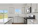 Modern kitchen featuring granite counters, stainless steel appliances and white subway tile backsplash at 9528 Maltese Dr, Gastonia, NC 28056