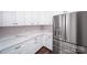 Well-appointed kitchen with white cabinets, marble countertops, and stainless steel appliances, offering style and functionality at 9528 Maltese Dr, Gastonia, NC 28056