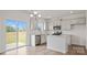 Modern kitchen featuring stainless steel appliances, granite countertops, an island, and sliding glass doors at 9528 Maltese Dr, Gastonia, NC 28056