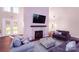 Comfortable living room showcasing a fireplace, contemporary furniture, and ample natural light, ideal for relaxation and gatherings at 9528 Maltese Dr, Gastonia, NC 28056
