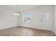 Bright living room with hardwood floors, large window, and decorative front door with windowed sidelight at 9528 Maltese Dr, Gastonia, NC 28056