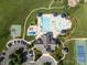 Overhead view of the community pool area featuring sun umbrellas, wading pool, and mature landscaping at 10217 Falling Leaf Dr, Concord, NC 28027