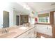 Bright bathroom featuring double sinks, large mirror, and separate tub and shower at 10217 Falling Leaf Dr, Concord, NC 28027