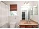 Bathroom with shower/tub combo, toilet, vanity, and window with blinds at 10217 Falling Leaf Dr, Concord, NC 28027