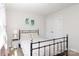 Comfortable bedroom with carpet, neutral walls, and a black metal bed frame at 10217 Falling Leaf Dr, Concord, NC 28027