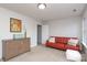 Cozy bonus room with neutral carpet, ample natural light, and stylish furniture arrangement at 10217 Falling Leaf Dr, Concord, NC 28027