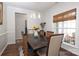 Elegant dining room with hardwood floors, decorative lighting, and comfortable seating for six at 10217 Falling Leaf Dr, Concord, NC 28027