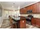 Bright and airy kitchen featuring stainless appliances, granite countertops, and breakfast bar seating at 10217 Falling Leaf Dr, Concord, NC 28027