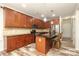 Well-equipped kitchen with granite countertops, stainless steel appliances, and a kitchen island at 10217 Falling Leaf Dr, Concord, NC 28027
