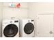 Laundry room with modern washer and dryer appliances and ample shelving at 10217 Falling Leaf Dr, Concord, NC 28027