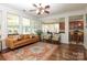 Cozy living room featuring hardwood floors, a comfortable sofa, and ample natural light at 10217 Falling Leaf Dr, Concord, NC 28027