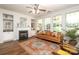 Bright living room boasts a fireplace, hardwood floors, large windows, and a comfortable seating arrangement at 10217 Falling Leaf Dr, Concord, NC 28027