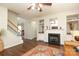 Living room features a fireplace, hardwood floors, staircase, and built-in shelving at 10217 Falling Leaf Dr, Concord, NC 28027