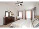 Inviting bedroom with large dresser, cozy chair, and soft neutral carpet at 10217 Falling Leaf Dr, Concord, NC 28027
