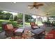 Comfortable covered patio with ceiling fans and outdoor seating area overlooks the backyard at 10217 Falling Leaf Dr, Concord, NC 28027