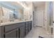 Bathroom features a double vanity, sleek gray cabinets, and a glass enclosed shower at 1022 Curling Creek Dr, Indian Trail, NC 28079