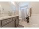 Bathroom features a single vanity, sleek gray cabinets, and shower with curtain at 1022 Curling Creek Dr, Indian Trail, NC 28079