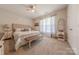 Inviting bedroom features a comfortable bed, a ceiling fan, and soft carpet flooring at 1022 Curling Creek Dr, Indian Trail, NC 28079