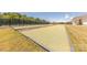 Community Bocce Ball court with green turf, a fence and seating nearby for neighborhood enjoyment at 1022 Curling Creek Dr, Indian Trail, NC 28079
