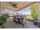 Covered patio with a spacious dining area, ceiling fan, and lush greenery, ideal for outdoor entertaining and relaxation at 1022 Curling Creek Dr, Indian Trail, NC 28079