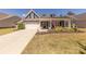 Charming single-Gathering home with a two-car garage, rocking chair porch, and attractive landscaping at 1022 Curling Creek Dr, Indian Trail, NC 28079