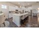 Spacious kitchen features white cabinets, stainless steel appliances, and a large island with seating at 1022 Curling Creek Dr, Indian Trail, NC 28079