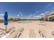 Community pool with lots of seating, umbrellas, and a clubhouse for residents to enjoy on sunny days at 1022 Curling Creek Dr, Indian Trail, NC 28079