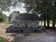 Charming home with a covered front porch, brick detail, and mature trees at 1105 Horton Ave, Kannapolis, NC 28083