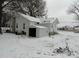 Rear exterior of a charming home with a backyard shed and snow-covered yard at 1105 Horton Ave, Kannapolis, NC 28083