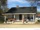 Inviting exterior featuring a cozy front porch with seating and a well-maintained yard at 1105 Horton Ave, Kannapolis, NC 28083