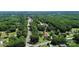 Expansive aerial shot of a lush neighborhood, featuring tree-lined streets and homes nestled among the greenery at 1105 S Point Rd, Belmont, NC 28012