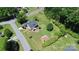 A nice home featuring a well-maintained yard, mature trees, and a detached garage at 1105 S Point Rd, Belmont, NC 28012