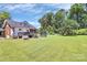 Spacious backyard featuring a well-maintained lawn, trampoline, and a deck at 1105 S Point Rd, Belmont, NC 28012