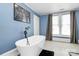 Blue bathroom offers a large soaking tub and patterned floor at 1105 S Point Rd, Belmont, NC 28012