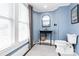 Light-filled bathroom features a stand alone sink, black framed mirror and a window with blinds at 1105 S Point Rd, Belmont, NC 28012