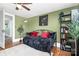 Bedroom with dark trundle bed, plant decor, and wood flooring at 1105 S Point Rd, Belmont, NC 28012