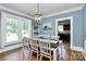 Well-lit dining room with hardwood floors and access to the kitchen, perfect for Gathering meals at 1105 S Point Rd, Belmont, NC 28012