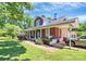Charming brick home with a covered porch and carport, showcasing its classic architectural style and curb appeal at 1105 S Point Rd, Belmont, NC 28012