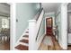Inviting hallway with wood floors, staircase, and a wooden door leading to another room at 1105 S Point Rd, Belmont, NC 28012