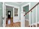 Hallway with hardwood floors, white doors, and natural light creates a welcoming entry at 1105 S Point Rd, Belmont, NC 28012