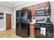 Traditional kitchen with a black refrigerator, wooden cabinets, and a black stove at 1105 S Point Rd, Belmont, NC 28012