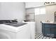 Bright laundry room with gray walls, modern washer and dryer, and a stylish blue vanity at 1105 S Point Rd, Belmont, NC 28012