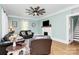 Cozy living room with hardwood floors, a decorative fireplace, and a stylish ceiling fan at 1105 S Point Rd, Belmont, NC 28012