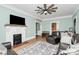 Comfortable living room featuring a brick fireplace, hardwood floors and a neutral color scheme at 1105 S Point Rd, Belmont, NC 28012