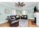 Bright living room showcasing hardwood floors, a decorative fireplace, and comfortable seating arrangement at 1105 S Point Rd, Belmont, NC 28012
