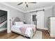 Inviting bedroom with gray walls, hardwood floors, and sliding door to an adjacent room at 1105 S Point Rd, Belmont, NC 28012